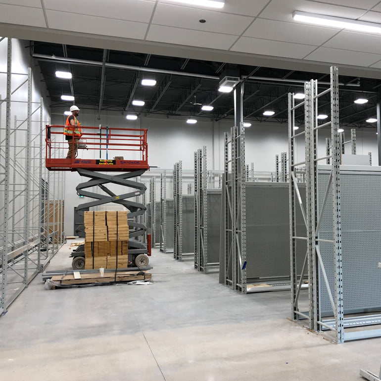 Installation team team setting up aisle racking in new retail store